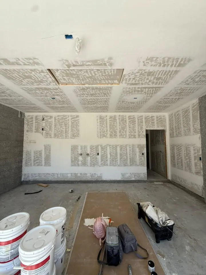 Drywall taped and mudded throughout a room