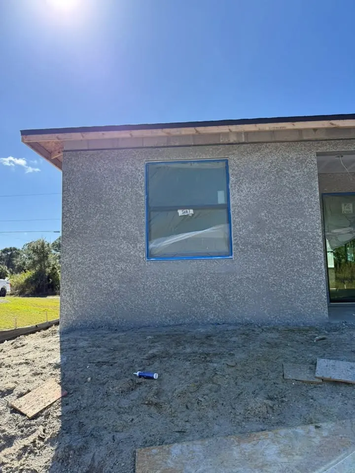 Unpainted stucco wall with a window
